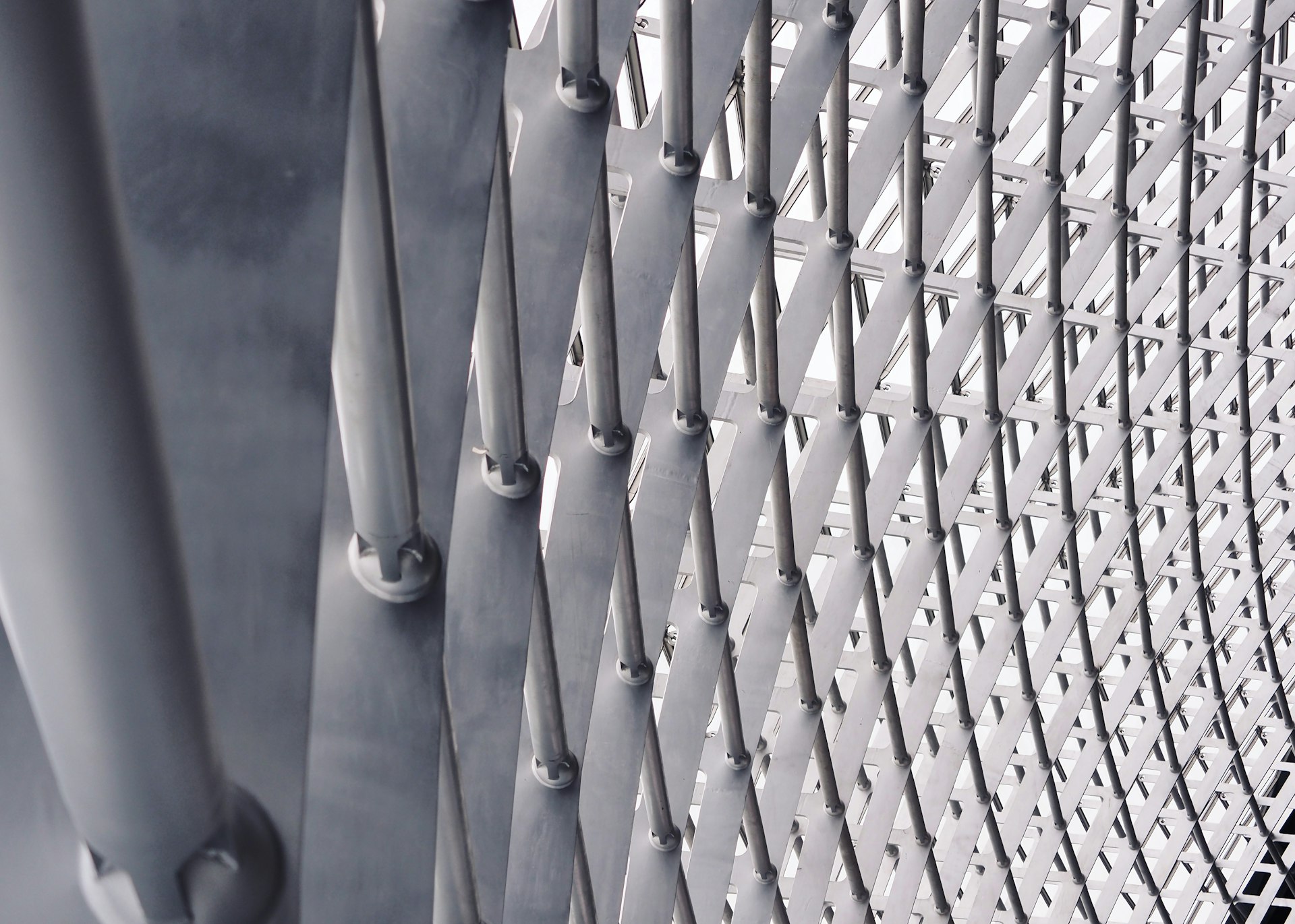 A close up of a metal fence with a sky background